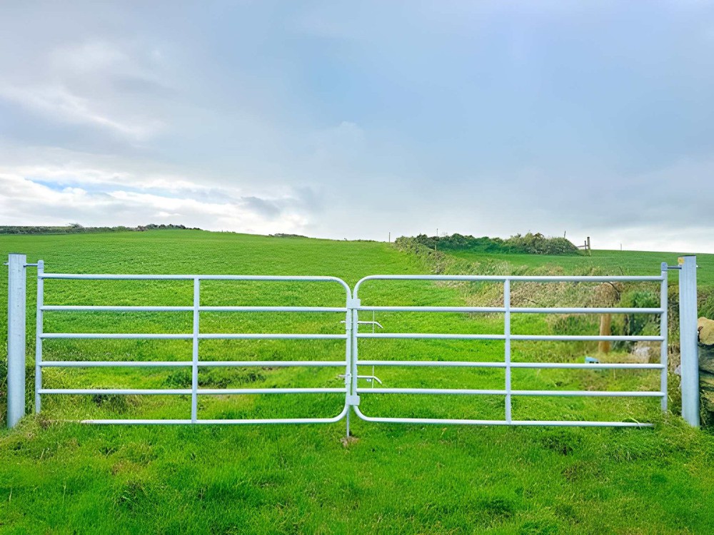 Galvanised steel farm gates at entrance to a field Galvanised steel farm gates at entrance to a field