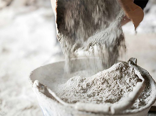 Filling a bucket with cement at construstion site Filling a bucket with cement at construstion site
